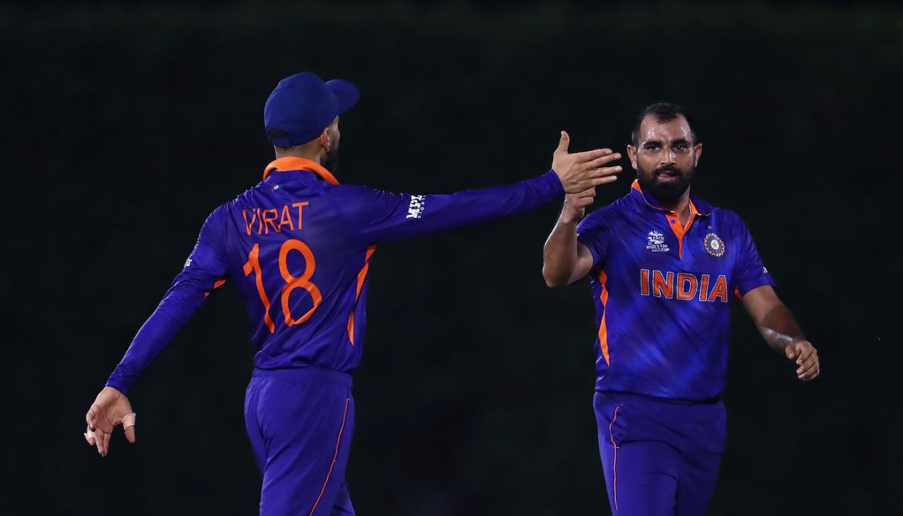 Mohammed Shami celebrates the wicket of Jos Buttler with Virat Kohli, Dubai, October 18, 2021