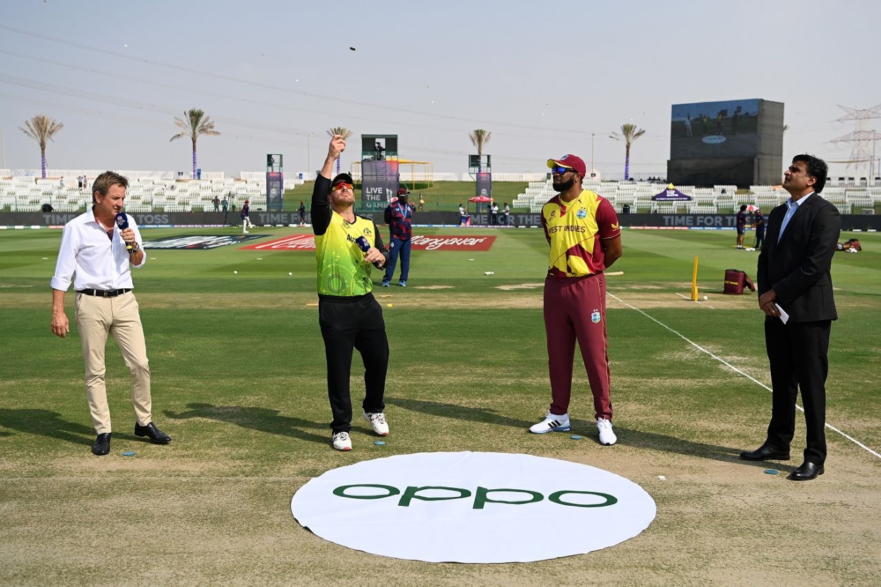 Aaron Finch flips the coin as Kieron Pollard looks on at the toss, Australia vs West Indies, Men's T20 World Cup 2021, Super 12s, Abu Dhabi, November 6, 2021