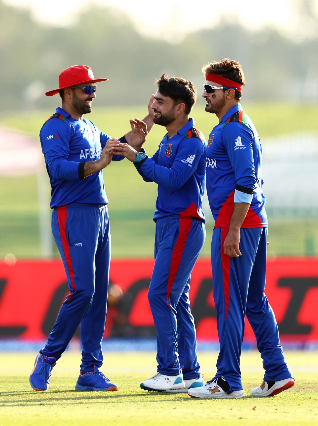 Mohammad Nabi and Hamid Hassan congratulate Rashid Khan after he picked up his 400th T20 wicket, Afghanistan vs New Zealand, T20 World Cup, Group 2, Abu Dhabi, November 7, 2021