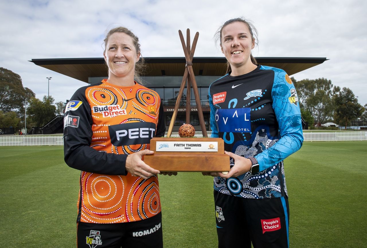 Sophie Devine and Tahlia McGrath, captains of Perth Scorchers and Adelaide Strikers respectively, pose with the Faith Thomas Trophy,  Adelaide, November 16, 2021