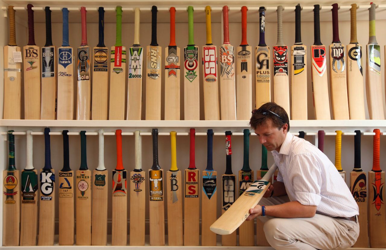 Oliver Wright of JS Wright & Sons a finished cricket bat made by the companies he supplies with willow clefts, Chelmsford, England, June 30, 2009
