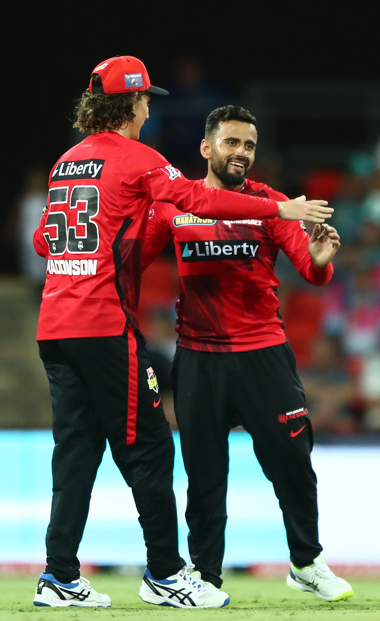 Zahir Khan is congratulated by his captain Nic Maddinson after picking up a wicket, Melbourne Renegades vs Brisbane Heat, BBL 2021-22, Carrara, December 13, 2021