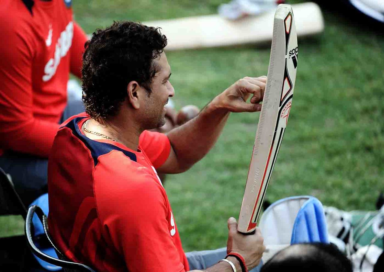 Sachin Tendulkar examines his bat during a training session, Mohali, March 28, 2011