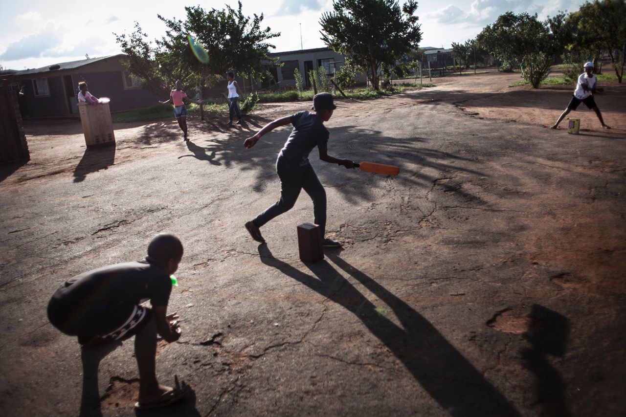 Kids play cricket in a housing area in Westonar, South Africa, March 12, 2016