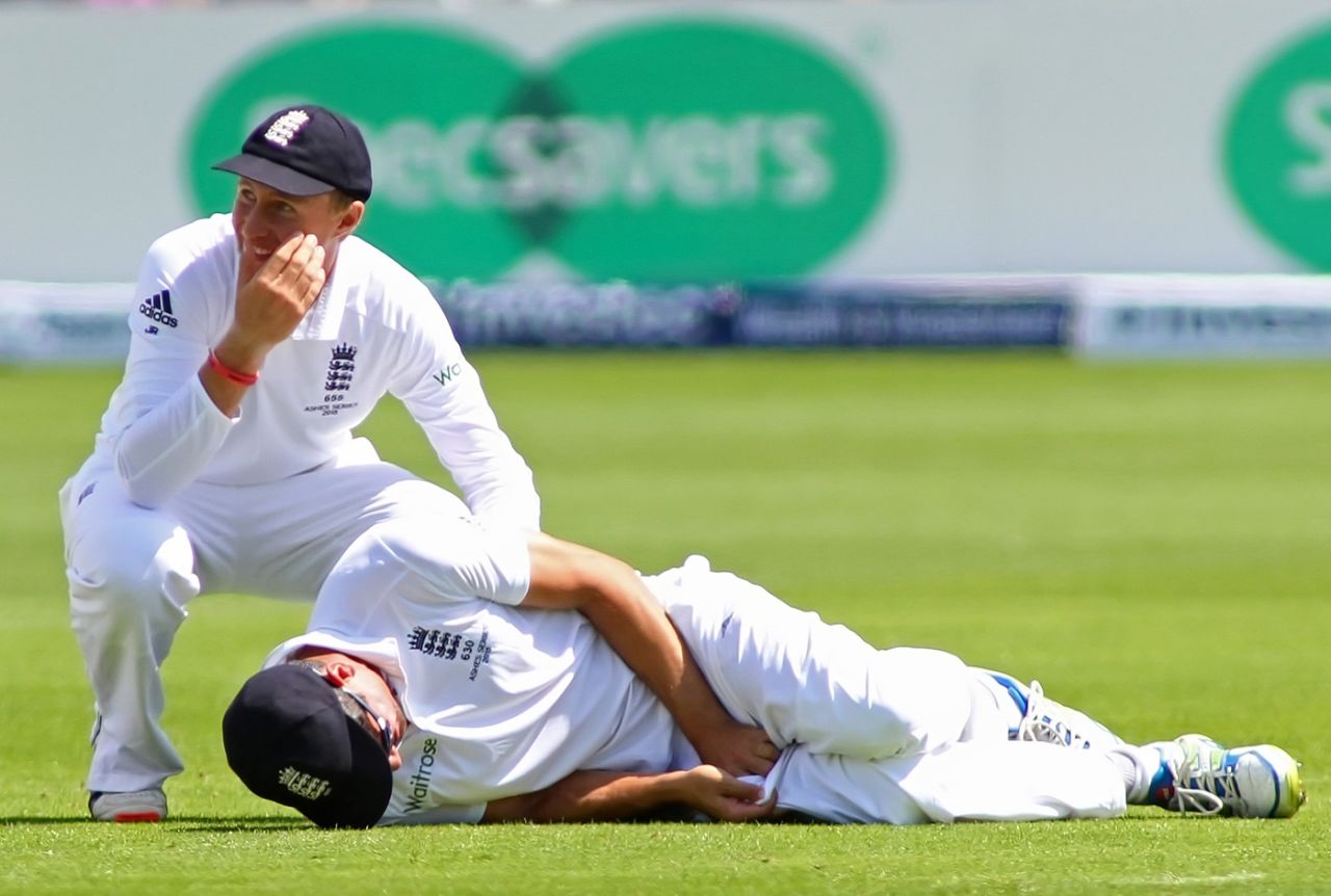 Joe Root giggles as Alastair Cook lies on the ground after being hit in the groin, England v Australia, 1st Investec Ashes Test, Cardiff, 2nd day, July 9, 2015