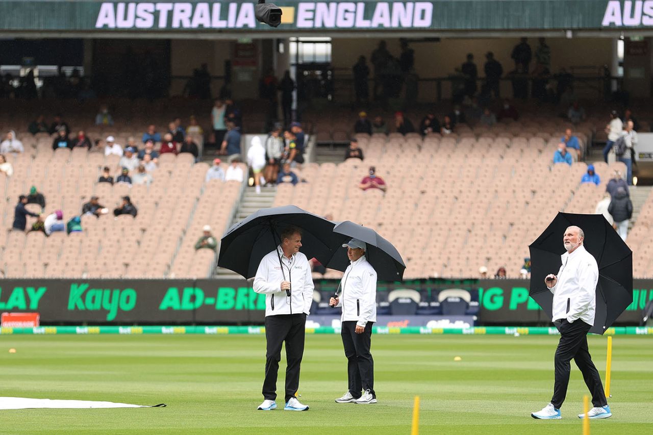 The umpires inspect the field as rain delays the coin toss, Australia vs England, 3rd Test, 1st day, MCG, December 26, 2021
