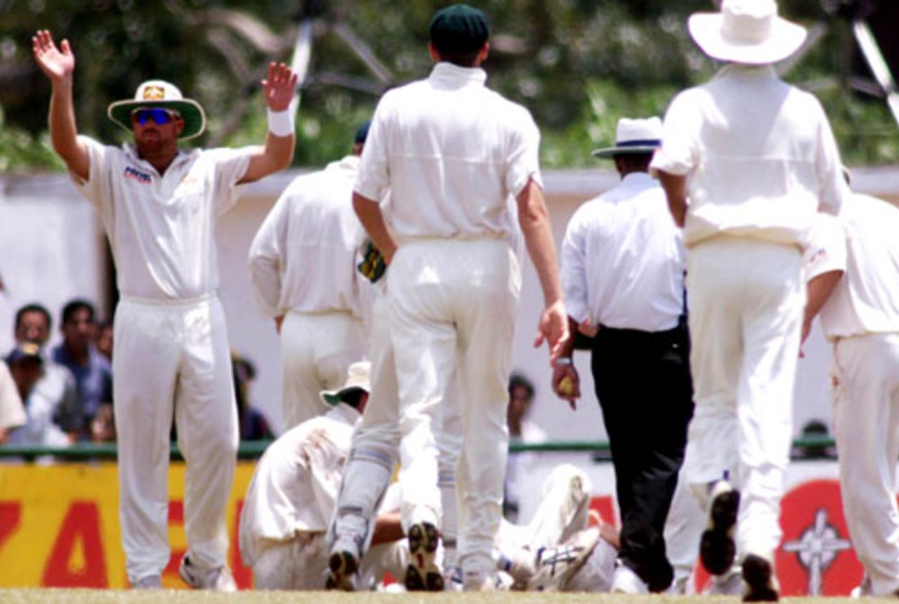 10 Sep 1999: Shane Warne calls for assistance after Jason Gillespie and Steve Waugh of Australia collided attempting a catch, during day two of the First Test between Sri Lanka and Australia at Asgiriya Stadium, Kandy, Sri Lanka.