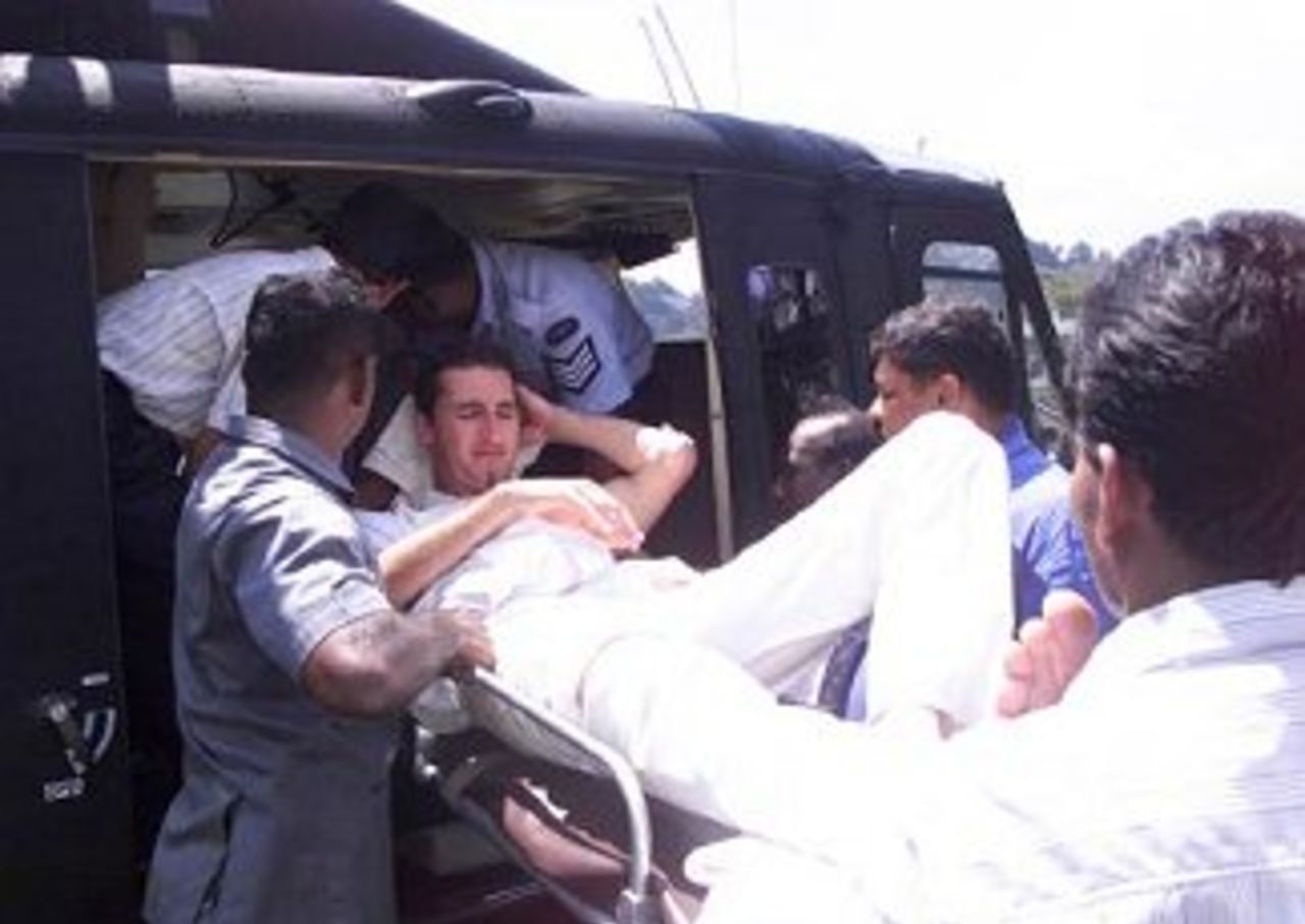 10 Sep 1999: Jason Gillespie is loaded into a military helicopter to betaken to Colombo after injuring his ankle, Kandy, Sri Lanka.