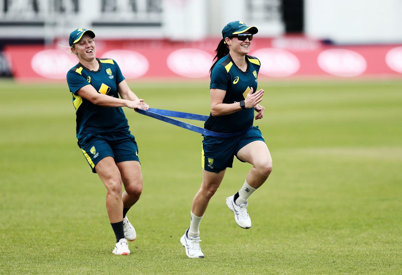 Alyssa Healy helps Megan Schutt run using a stretch band, Grace Road, July 1, 2019