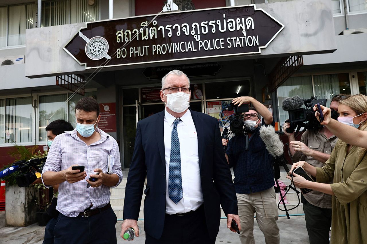 Australia's Ambassador to Thailand Allan McKinnon (centre) outside Bo Phut police station, Koh Samui, March 6, 2022