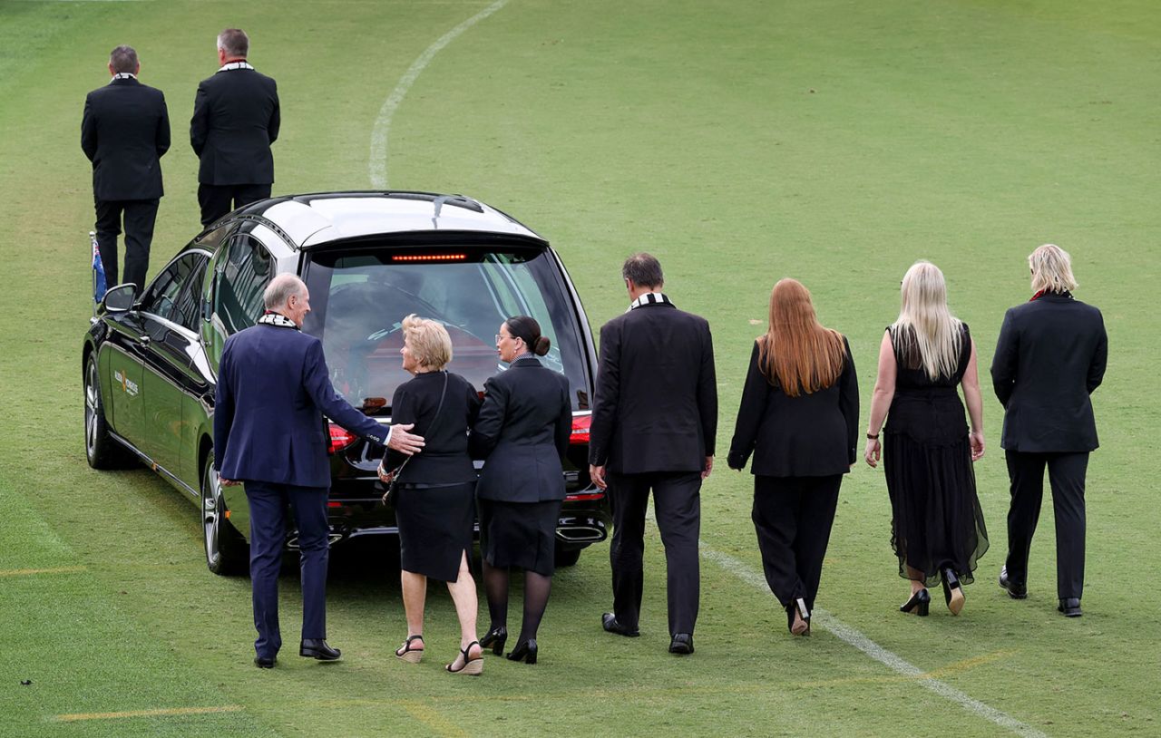 Shane Warne's family follow the hearse on a lap of St Kilda Football Club after the private funeral, Melbourne, March 20, 2022