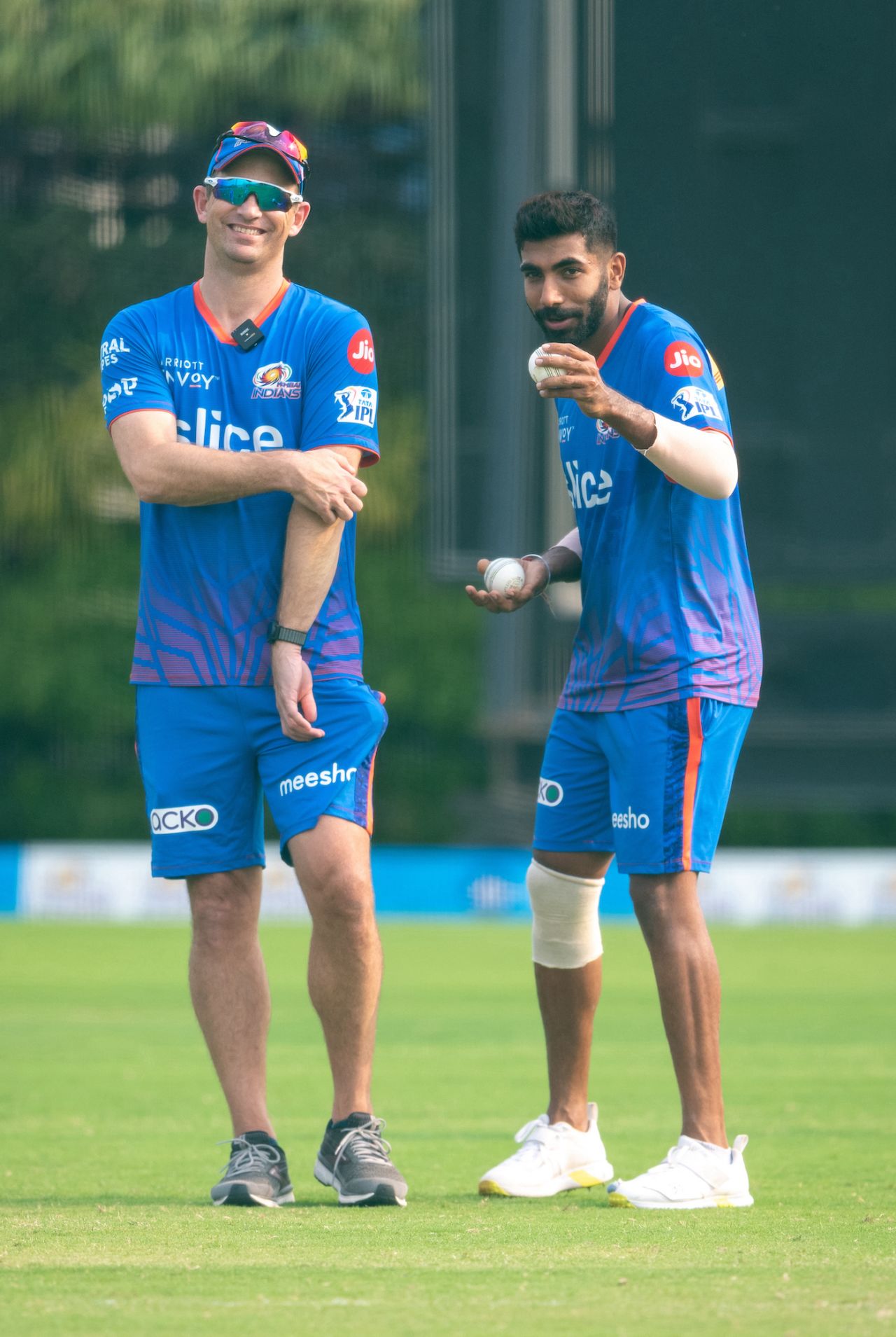 Shane Bond and Jasprit Bumrah share a laugh, Mumbai, March 26, 2022