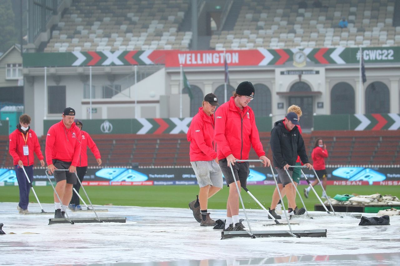 The Basin Reserve groundstaff at work to remove water off the rain covers, Australia vs West Indies, 1st semi-final, 2022 Women's ODI World Cup, Wellington, March 30, 2022