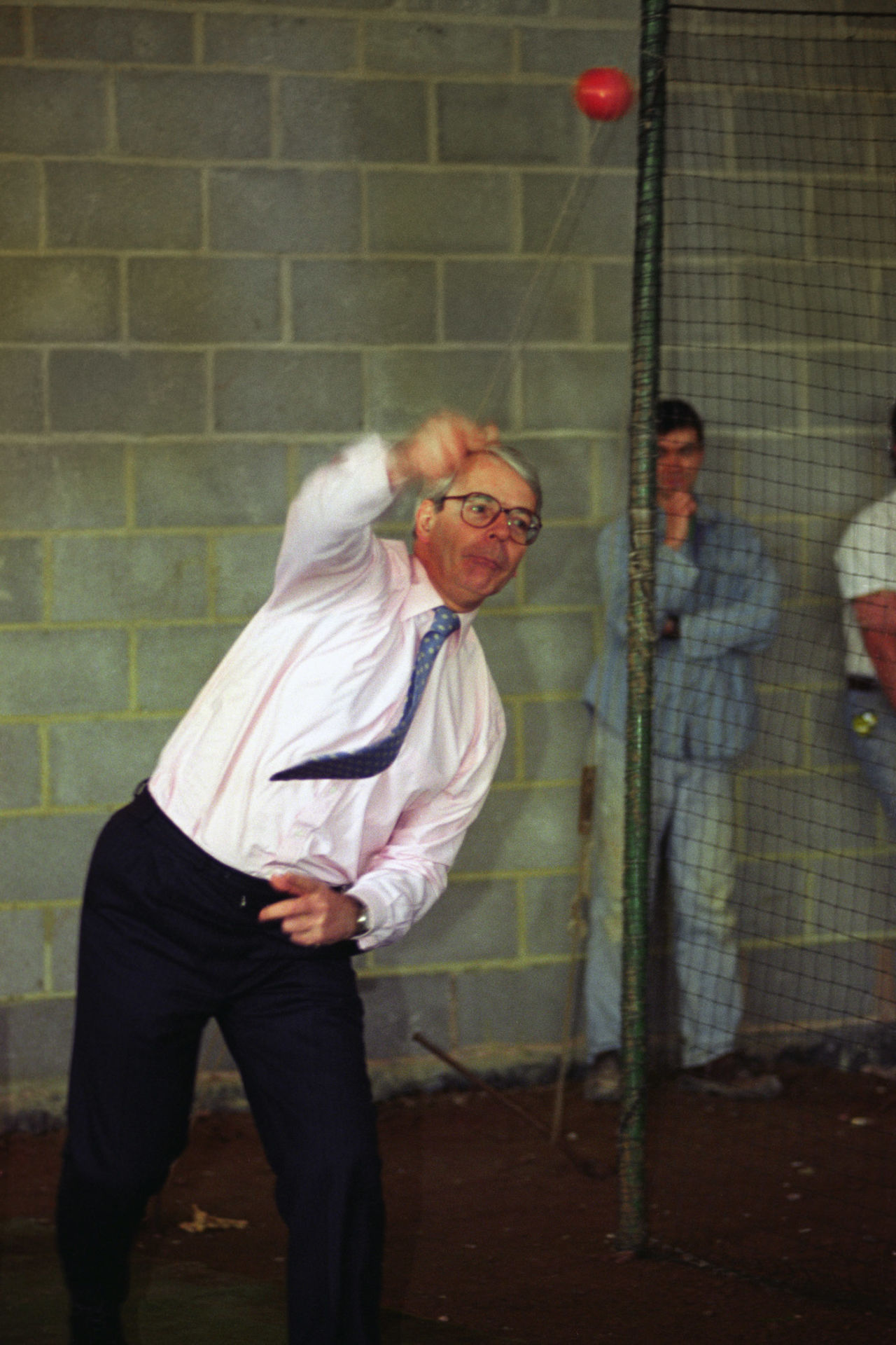 John Major bowls in the nets at Somerset cricket club's indoor cricket school at Taunton, April 7, 1995
