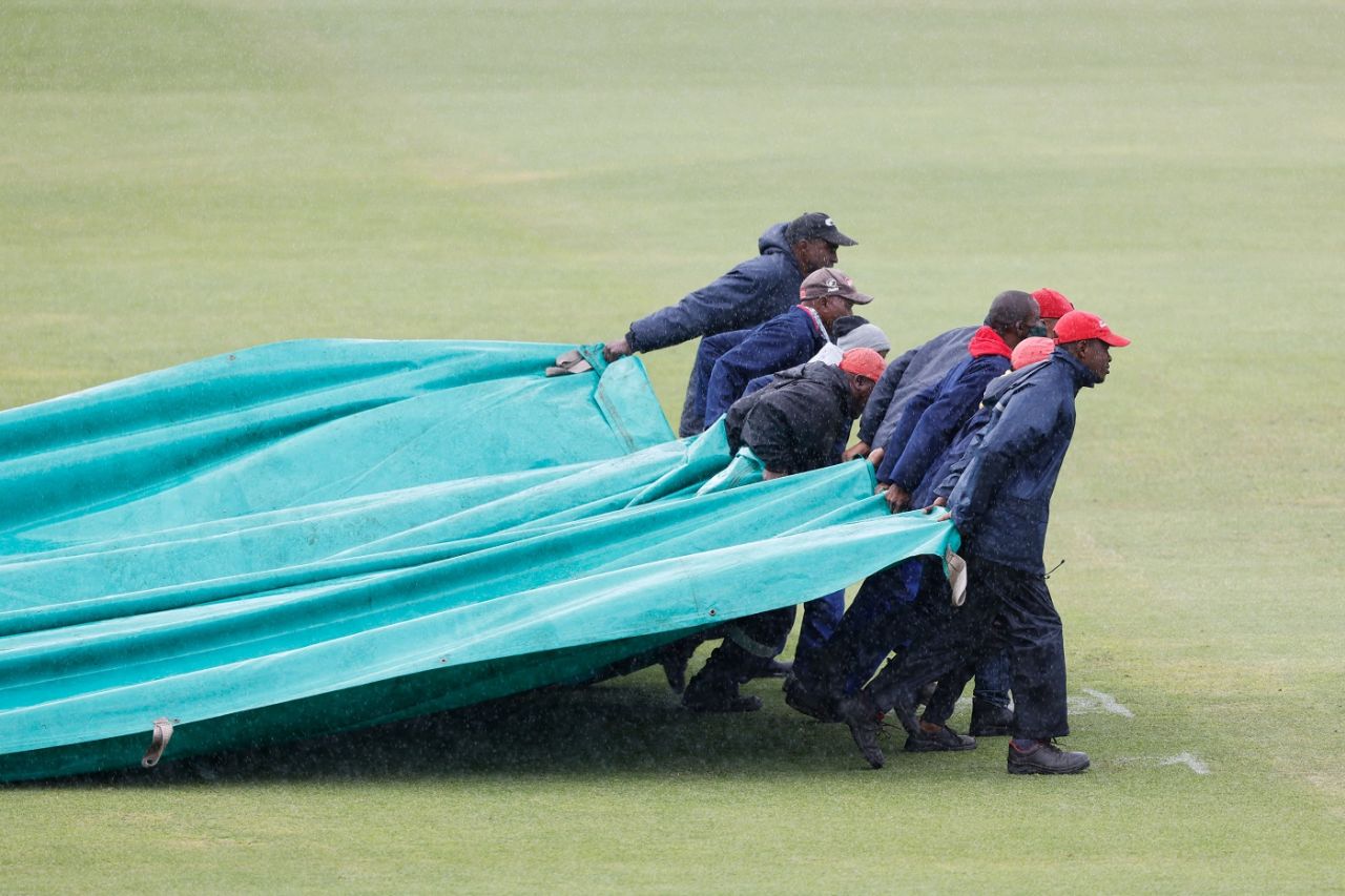 The ground staff get the covers out, South Africa v Bangladesh, 2nd Test, Gqeberha, 1st day, April 8, 2022