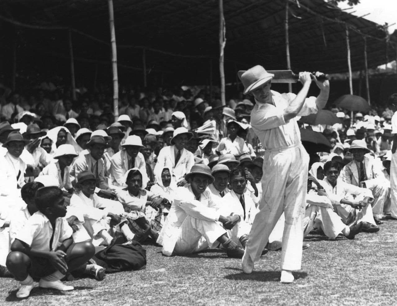 Australian cricketer Lindsay Hassett practising before a match at Colombo, in front of a crowd of spectators, April 6, 1938