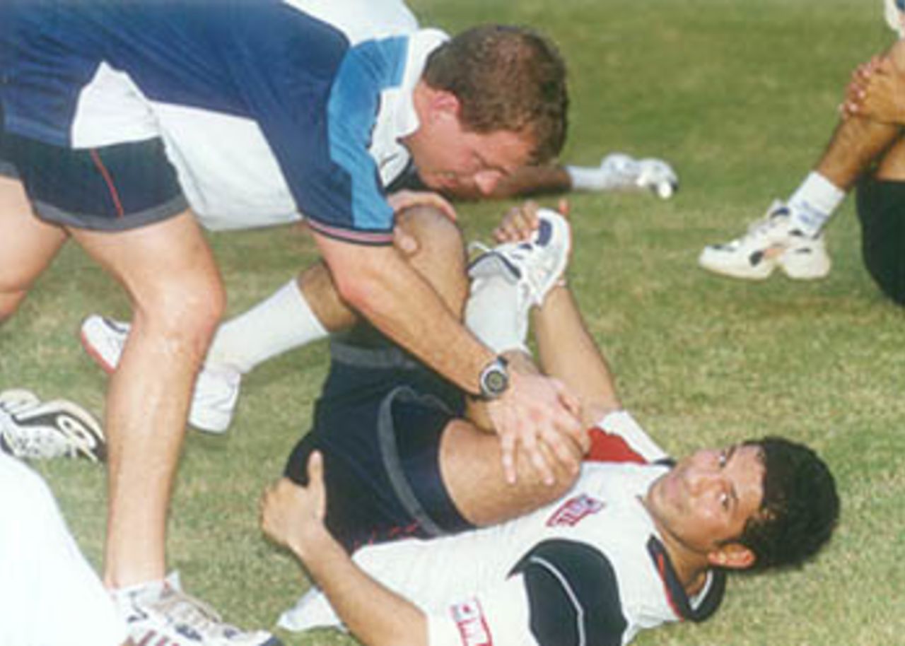Leipus helps Tendulkar to stretch his muscles during the camp, MRF Pace Foundation, Chennai, 14 Sep 2000.