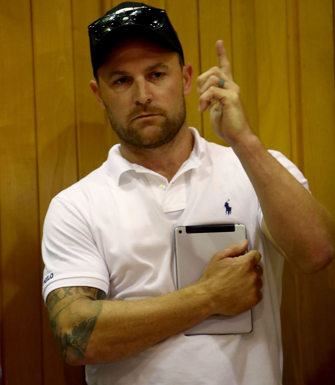 Brendon McCullum holds a tablet while bidding at an auction for horses, Auckland, January 30, 2018
