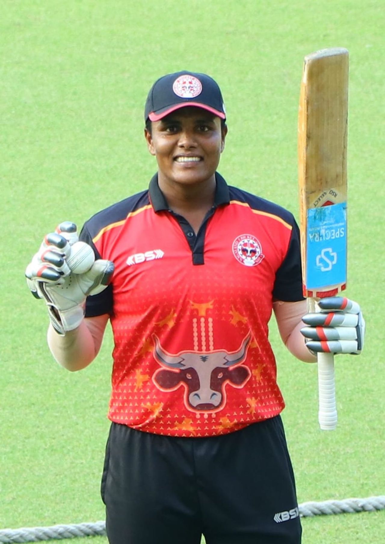 Kiran Navgire poses with her bat and ball