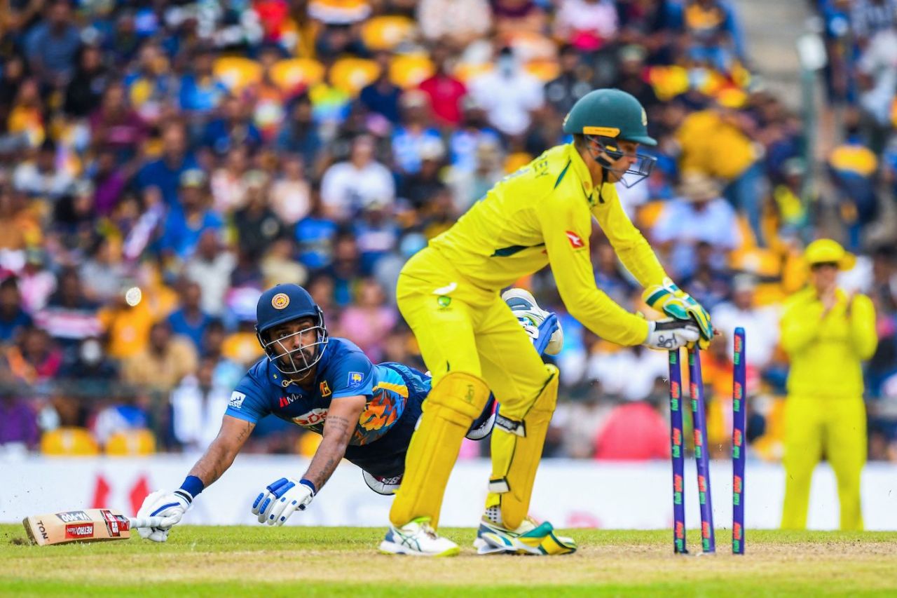 Alex Carey breaks the stumps to send back Danushka Gunathilaka - Australia's first wicket on the day, Sri Lanka vs Australia, 1st ODI, Pallekele, June 14, 2022