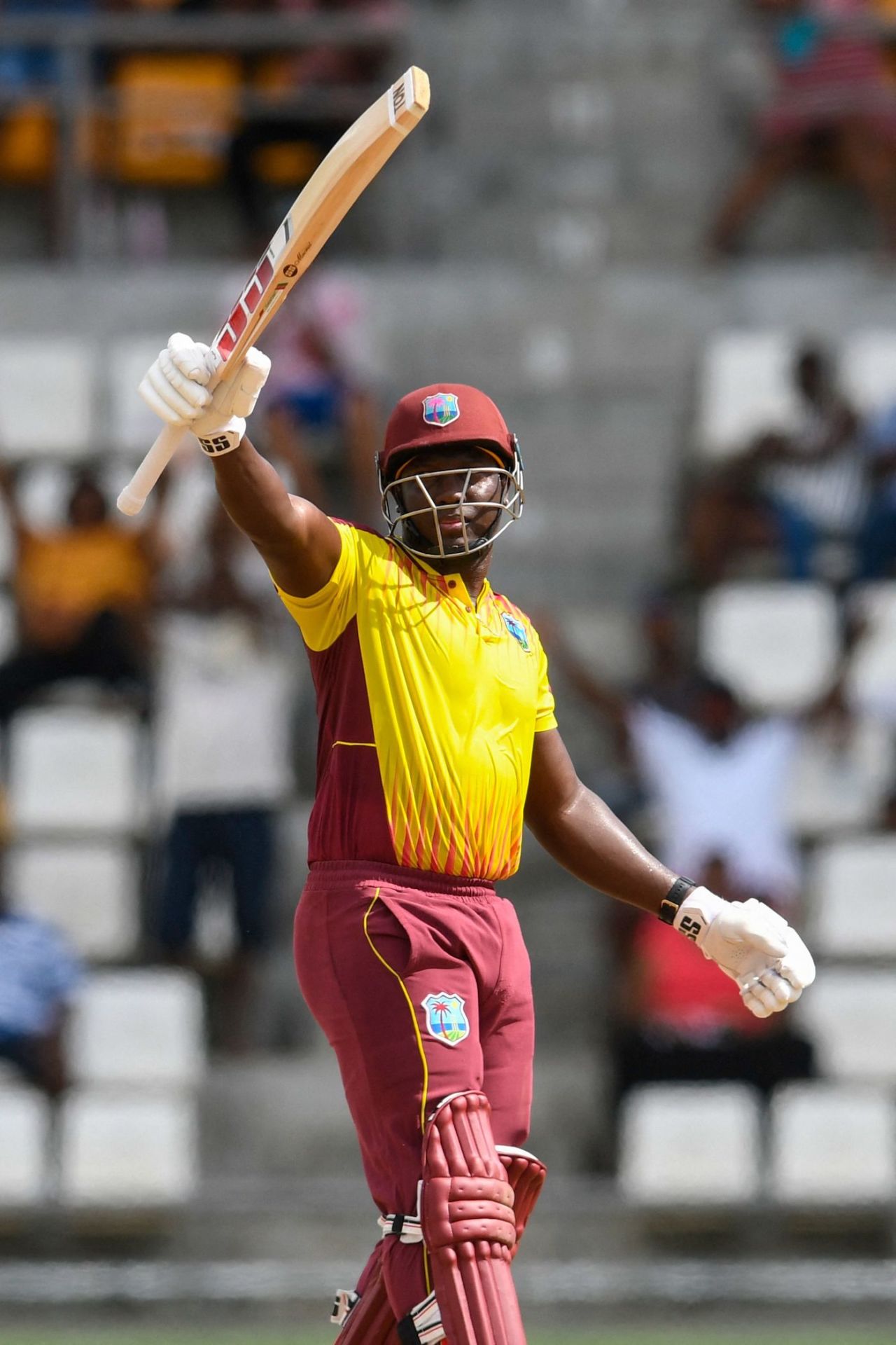 Rovman Powell raises his bat upon reaching fifty, West Indies vs Bangladesh, 2nd T20I, Roseau, July 3, 2022