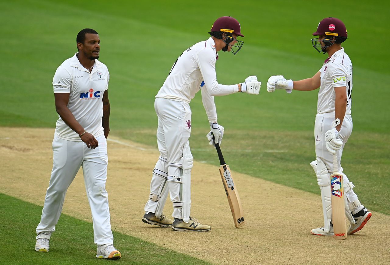 Kasey Aldridge and Lewis Gregory fist-bump as Shannon Gabriel walks back to his mark, LV= Insurance County Championship, Division 1, Somerset vs Yorkshire, Taunton, July 20, 2022