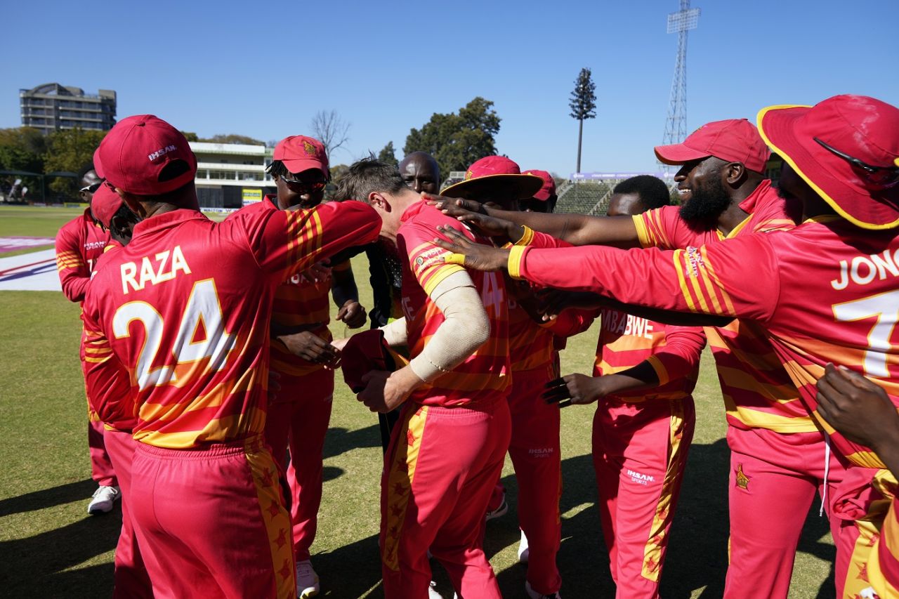 Brad Evans is mobbed by his team-mates after receiving his ODI cap, Zimbabwe vs Bangladesh, 2nd ODI, Harare, August 7, 2022