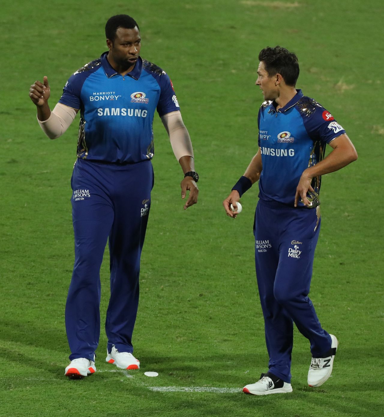 Kieron Pollard and Trent Boult have a chat during Mumbai Indians' match against Chennai Super Kings, Sharjah, October 23, 2020
