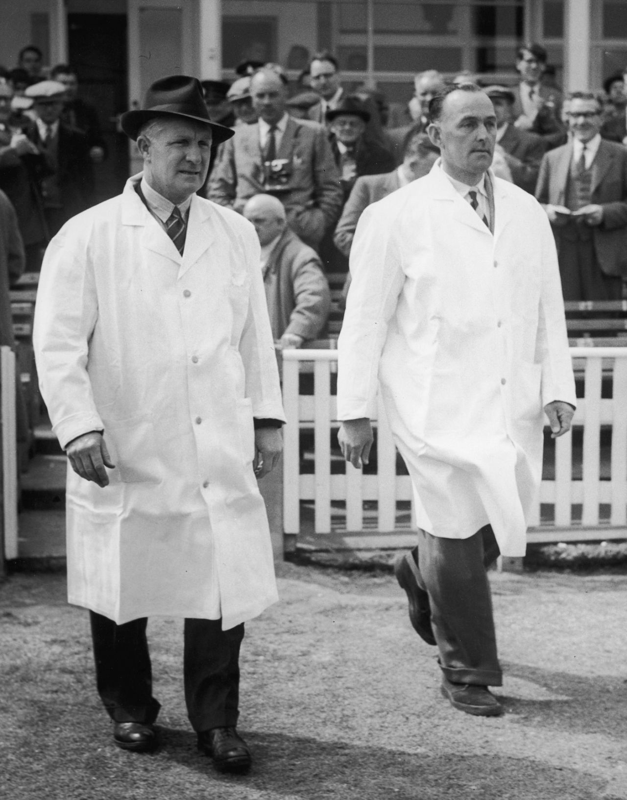 Umpires Emrys Davies and Charlie Elliott walk out on to the field, West Indies tour of England, 1957