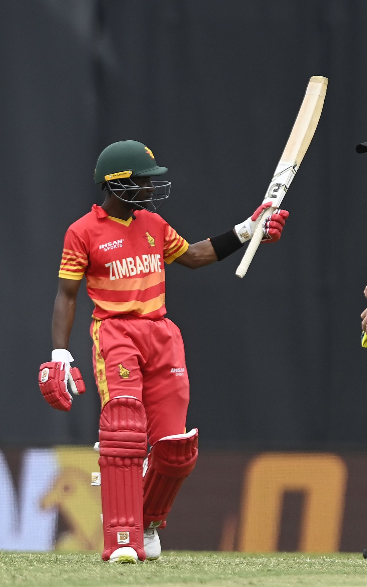 Wessly Madhevere raises his blade after his half-century, Australia vs Zimbabwe, 1st ODI, Townsville, August 28, 2022