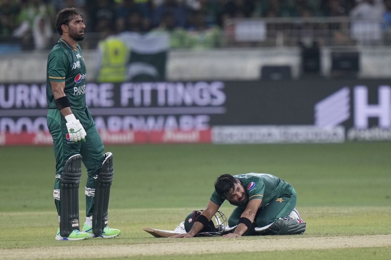 Mohammad Rizwan stretches as he and Iftikhar Ahmed wait for third umpire's decision, Sri Lanka vs Pakistan, Asia Cup final, Dubai, September 11, 2022
