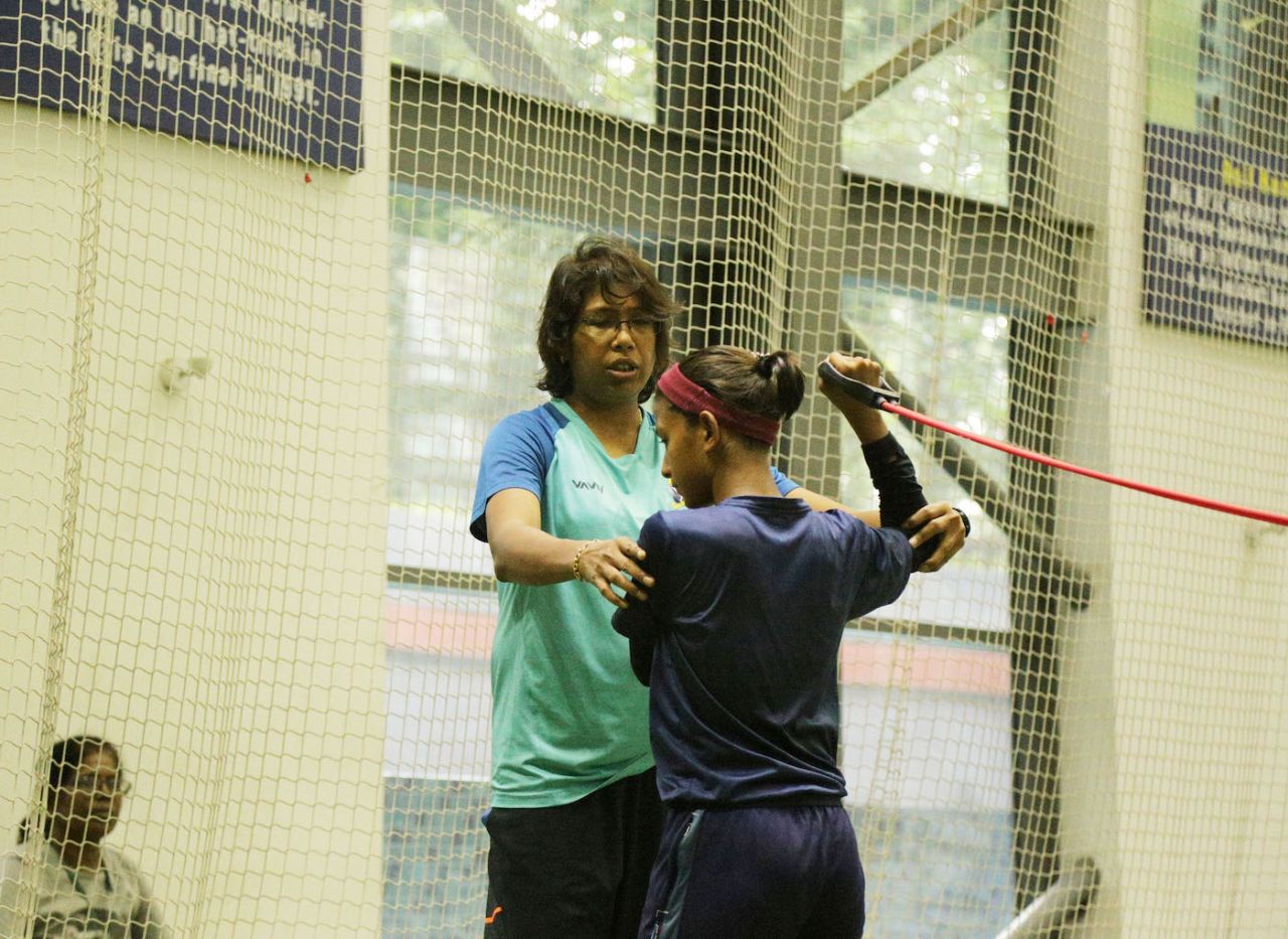 Jhulan Goswami adjusts the position of a young player's arms at a training session, Kolkata, September 2022