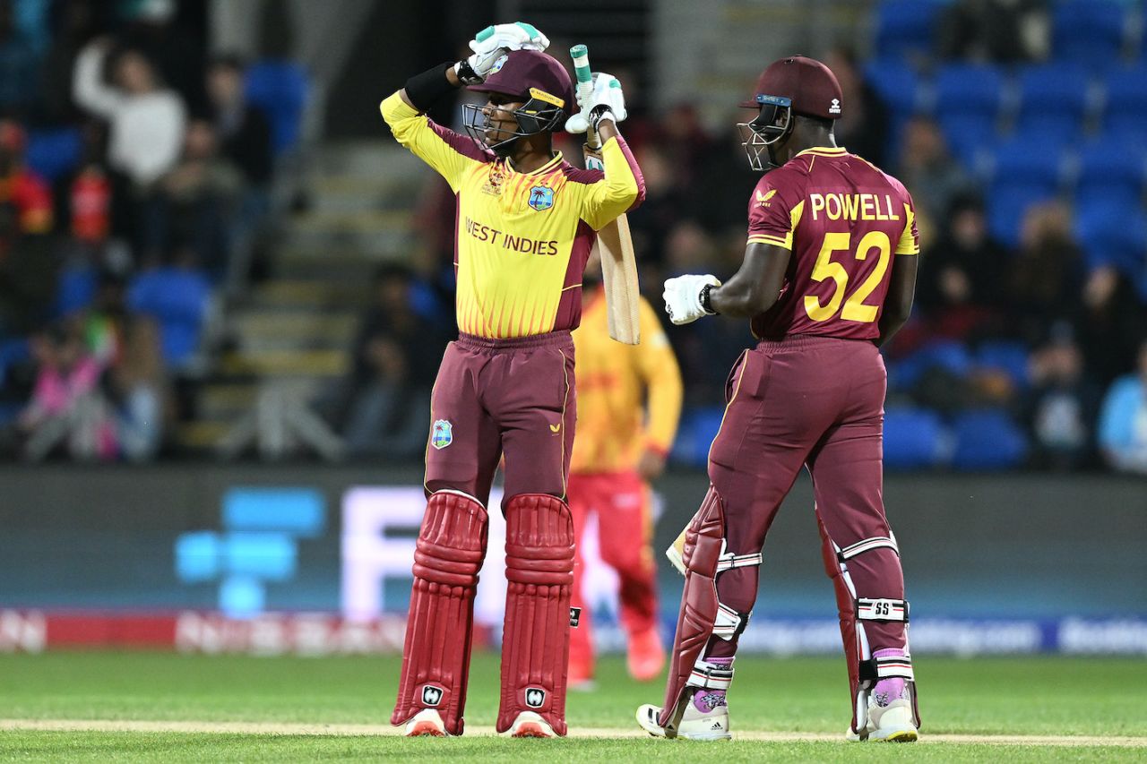 Akeal Hosein and Rovman Powell react during their 49-run stand, West Indies vs Zimbabwe, ICC Men's T20 World Cup, Hobart, October 19, 2022