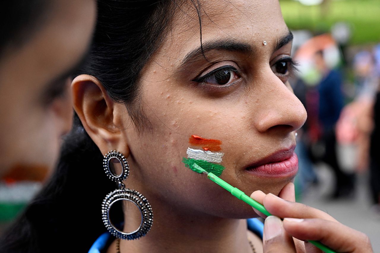 A fan gets the Indian flag painted on her cheek, India vs Pakistan, Men's T20 World Cup 2022, Super 12s, MCG/Melbourne, October 23, 2022