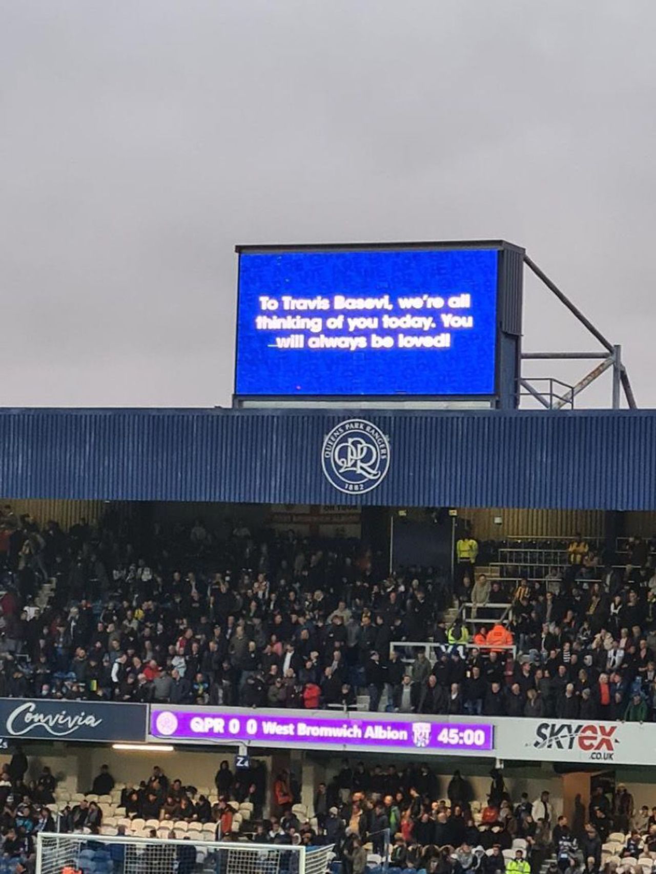 A message on the big screen at Loftus Road remembering Travis Basevi, a long-term Queens Park Rangers fan