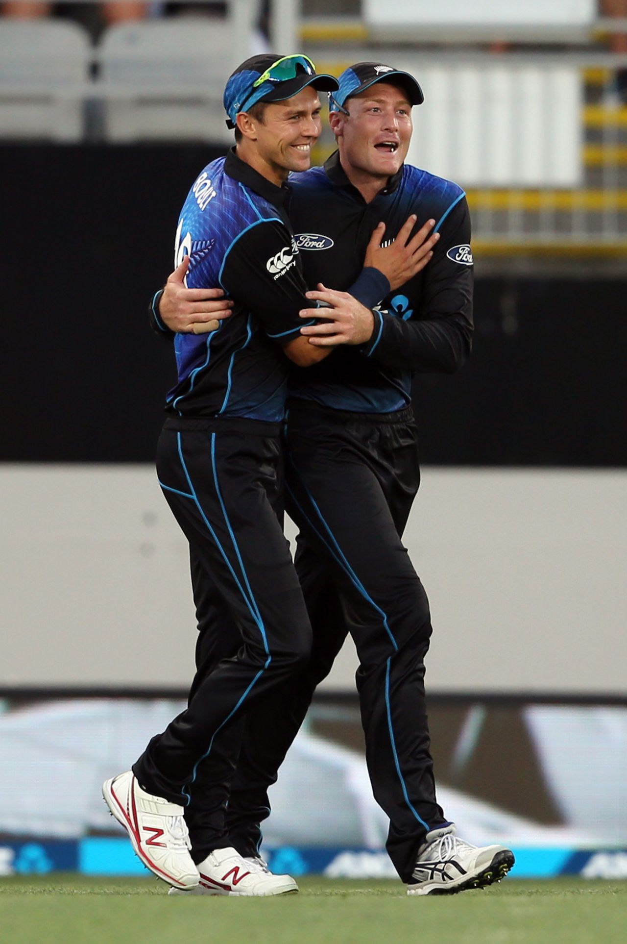 Trent Boult and Martin Guptill celebrate a wicket, Auckland, February 3, 2016
