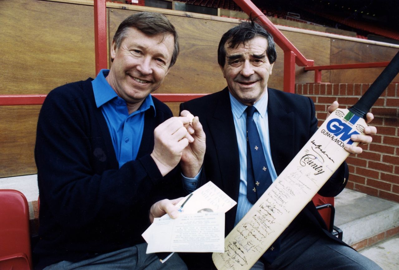 Manchester United manager Alex Ferguson and Fred Truman pose with an autographed bat that is to be raffled to raise money for a special spinal injury centre, November 19, 1994