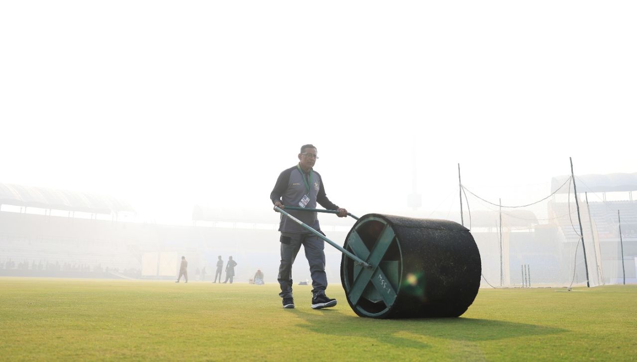 The fog hangs over Multan as the groundsman rolls the nets, December 8, 2022