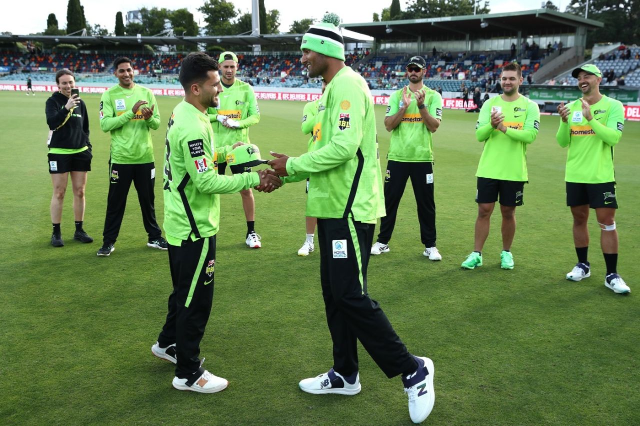 Gurinder Sandhu presents a cap to Afghanistan's Fazalhaq Farooqi, Melbourne Stars v Sydney Thunder, BBL 2022-23, December 13, 2022