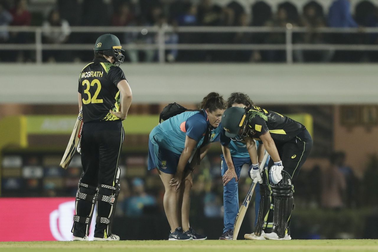 Tahlia McGrath looks on as physios tend to Alyssa Healy after she strained her calf playing a shot, India vs Australia, 4th T20I, Mumbai, December 17, 2022