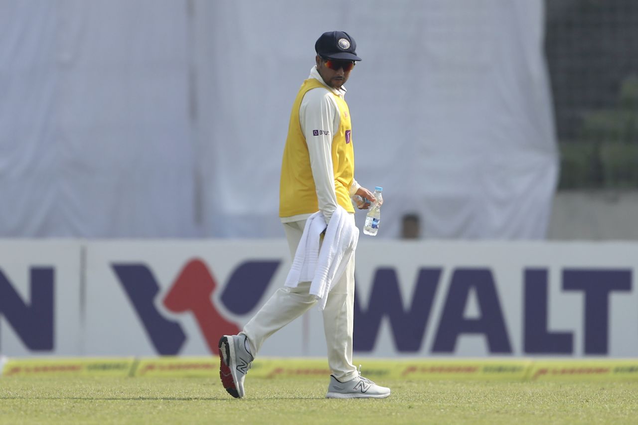 Kuldeep Yadav has a look at the ground as he carries drinks, Bangladesh vs India, 2nd Test, Mirpur, 2nd Day, December 23, 2022
