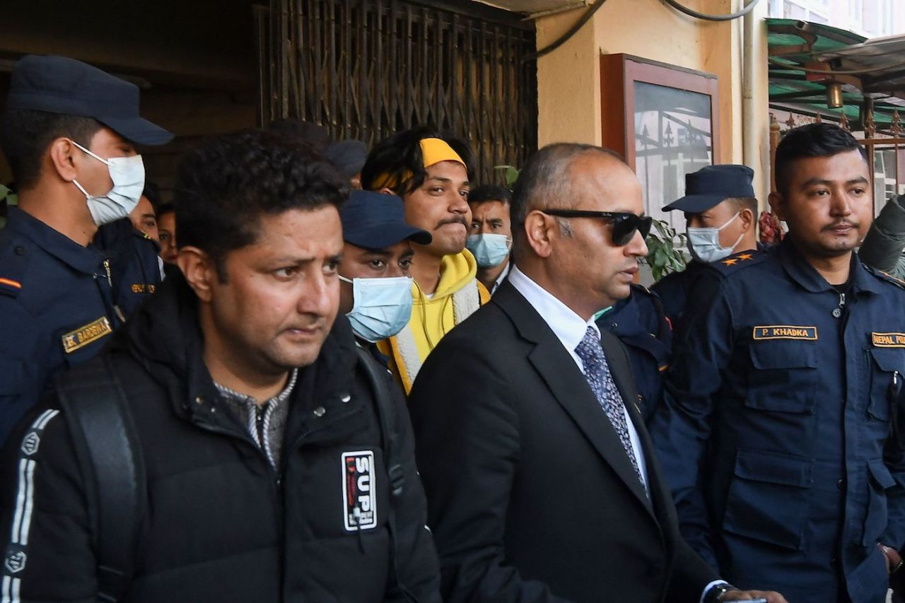 Sandeep Lamichhane is escorted by police outside the district court in Kathmandu, January 13, 2023