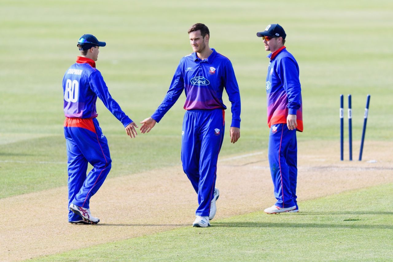 Ben Lister celebrates with his Auckland team-mates Mark Chapman and Colin Munro