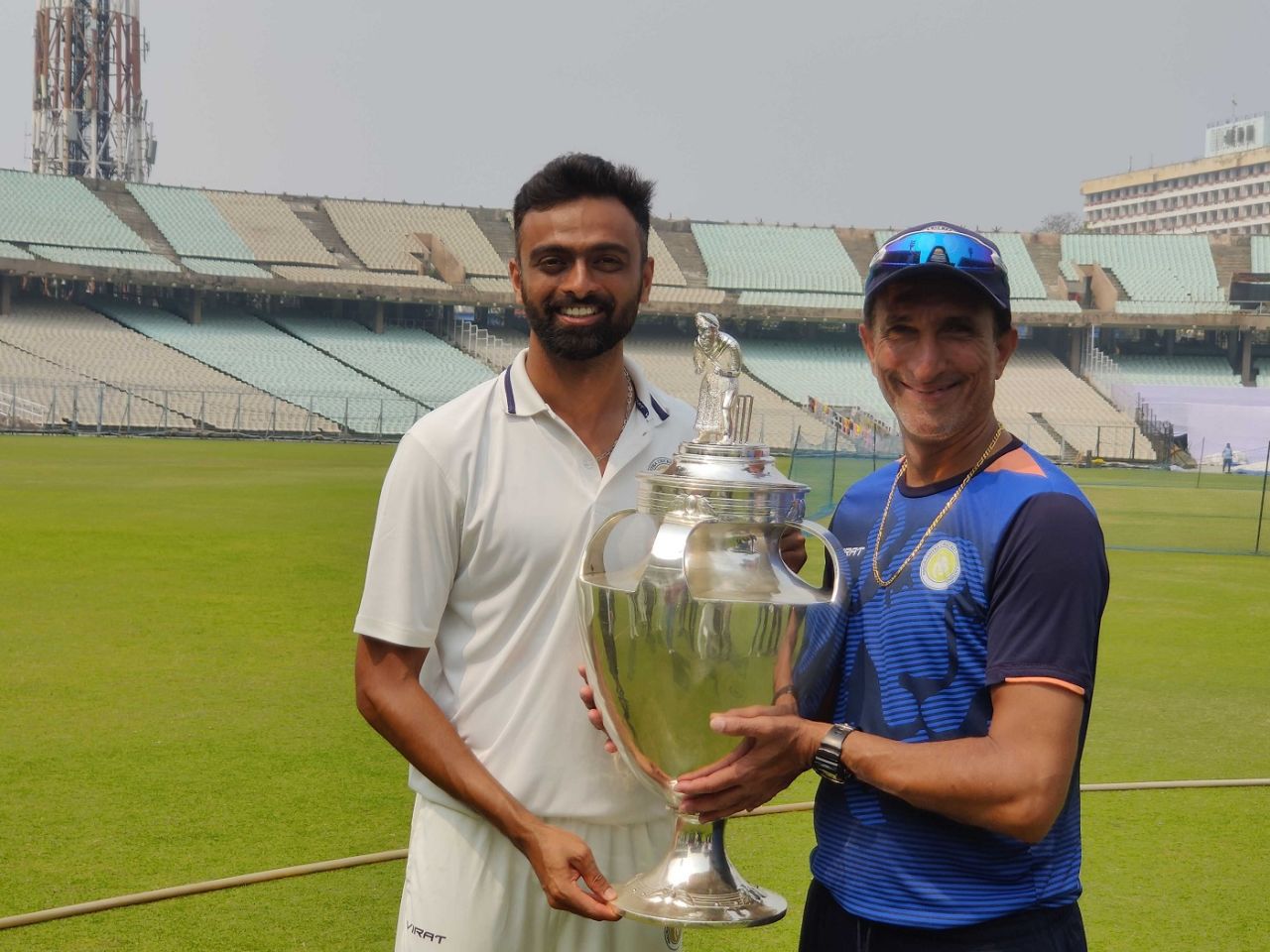 Saurashtra's proud captain and coach: Jaydev Unadkat and Niraj Odedra pose with the Ranji Trophy, Bengal vs Saurashtra, Ranji Trophy 2022-23 final, Kolkata, 4th day, February 19, 2023
