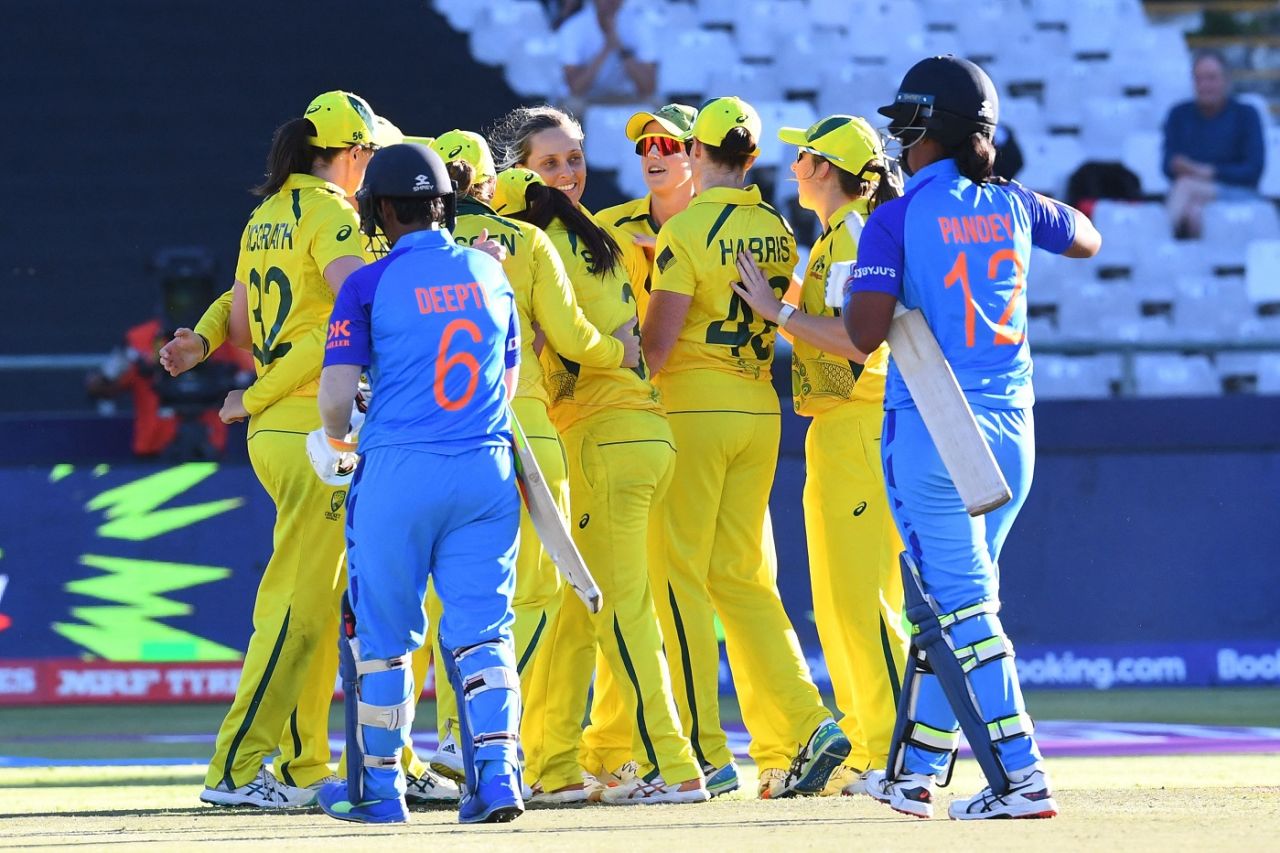 Australia celebrate their semi-final victory as a disappointed Deepti Sharma and Shikha Pandey walk back, Australia vs India, Women's T20 World Cup 2023, semi-final, Cape Town, February 23, 2023