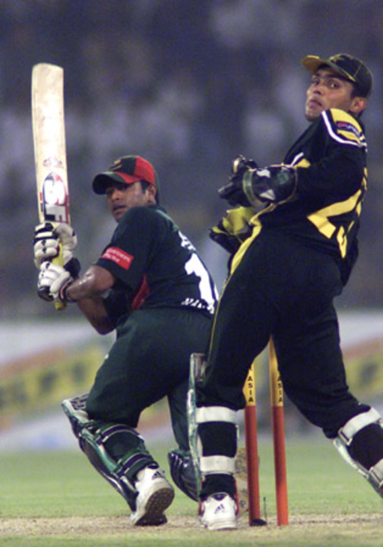 Alok Kapali sweeps on his way to a fifty, Pakistan v Bangladesh, 3rd ODI, Lahore, September 15, 2003.