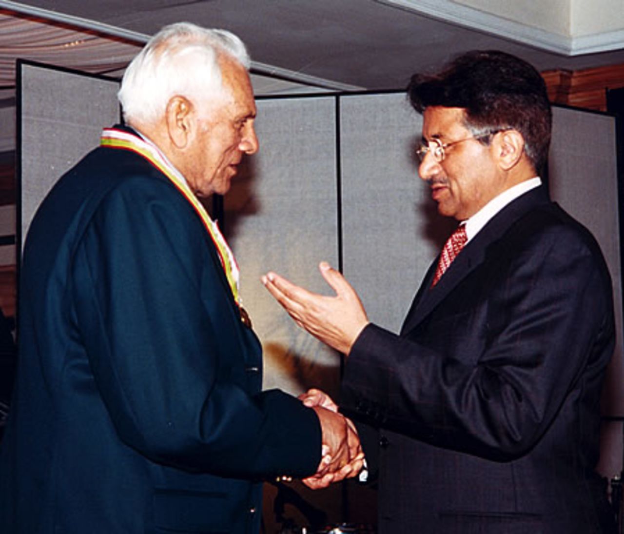 Khan Mohammad receiving his medal from Pakistan president during the Golden Jubilee of Test Cricket Gala, Islamabad, September 16, 2003.