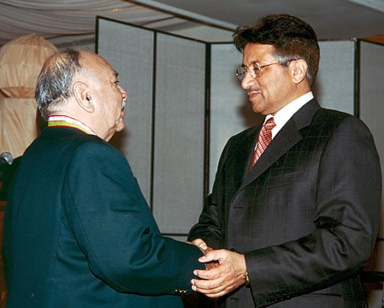 Zulfiqar Ahmed receiving his medal from Pakistan president during the Golden Jubilee of Test Cricket Gala, Islamabad, September 16, 2003.
