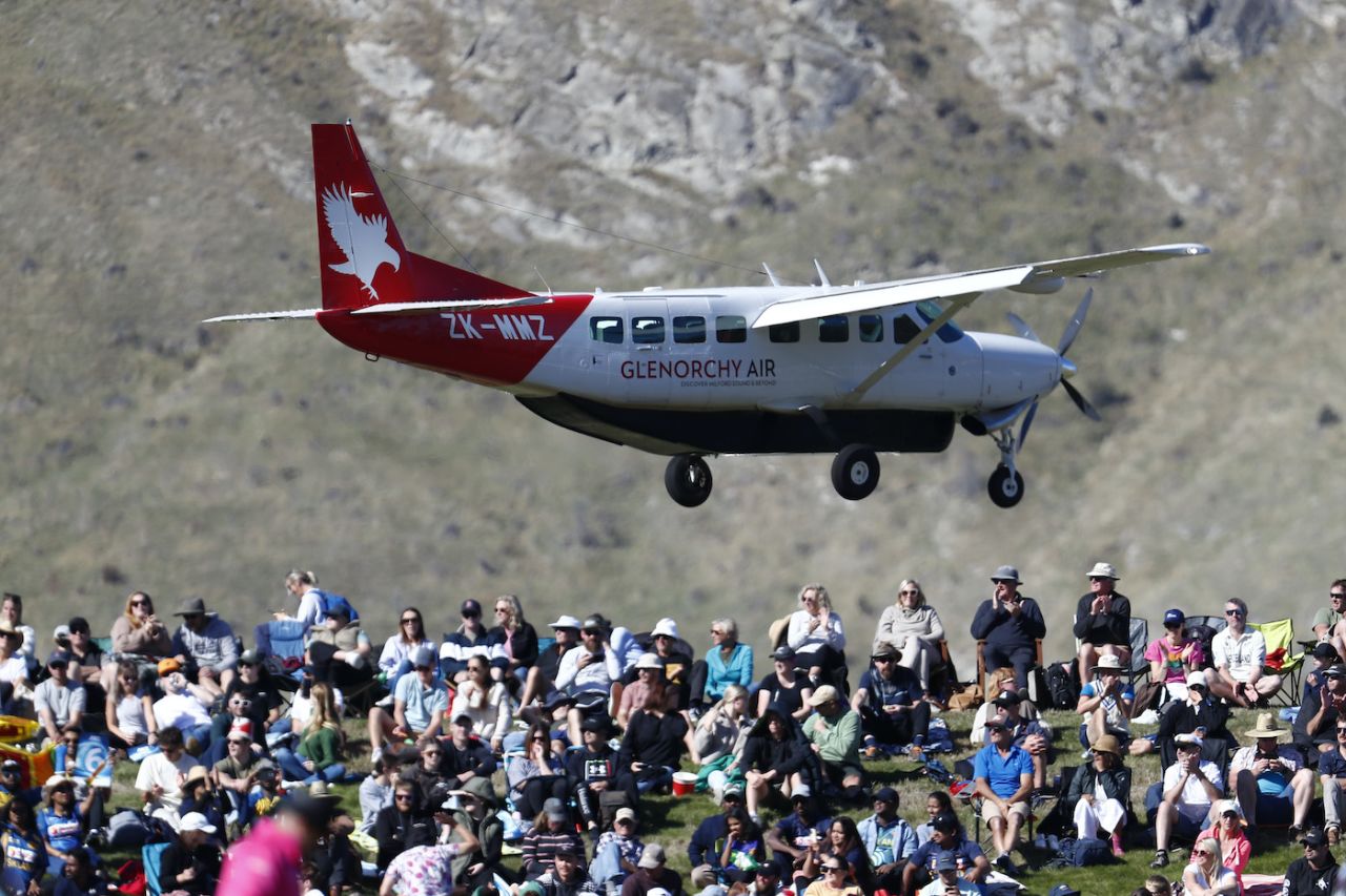 A plane flies over the crowd on the grass banks, New Zealand vs Sri Lanka, 3rd T20I, Queenstown, April 08, 2023