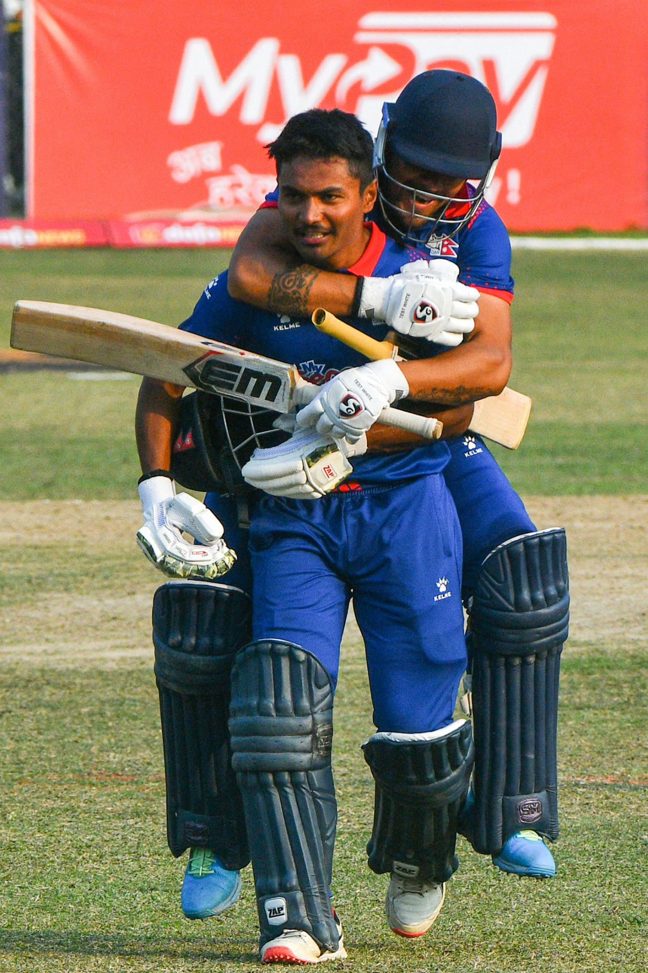 Karan KC leaps onto captain Rohit Paudel's back after they sealed the win, Nepal vs Scotland, ICC Men's Cricket World Cup League 2, Kirtipur, February 21, 2023